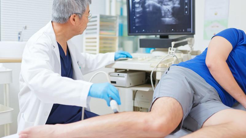 A physician using a machine to examine a patient.