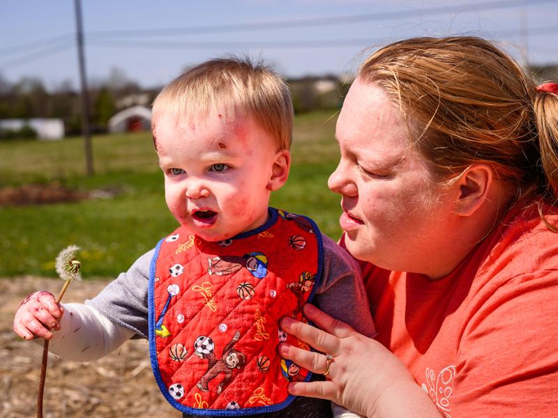 A photo of Matthew and his mother at the park.