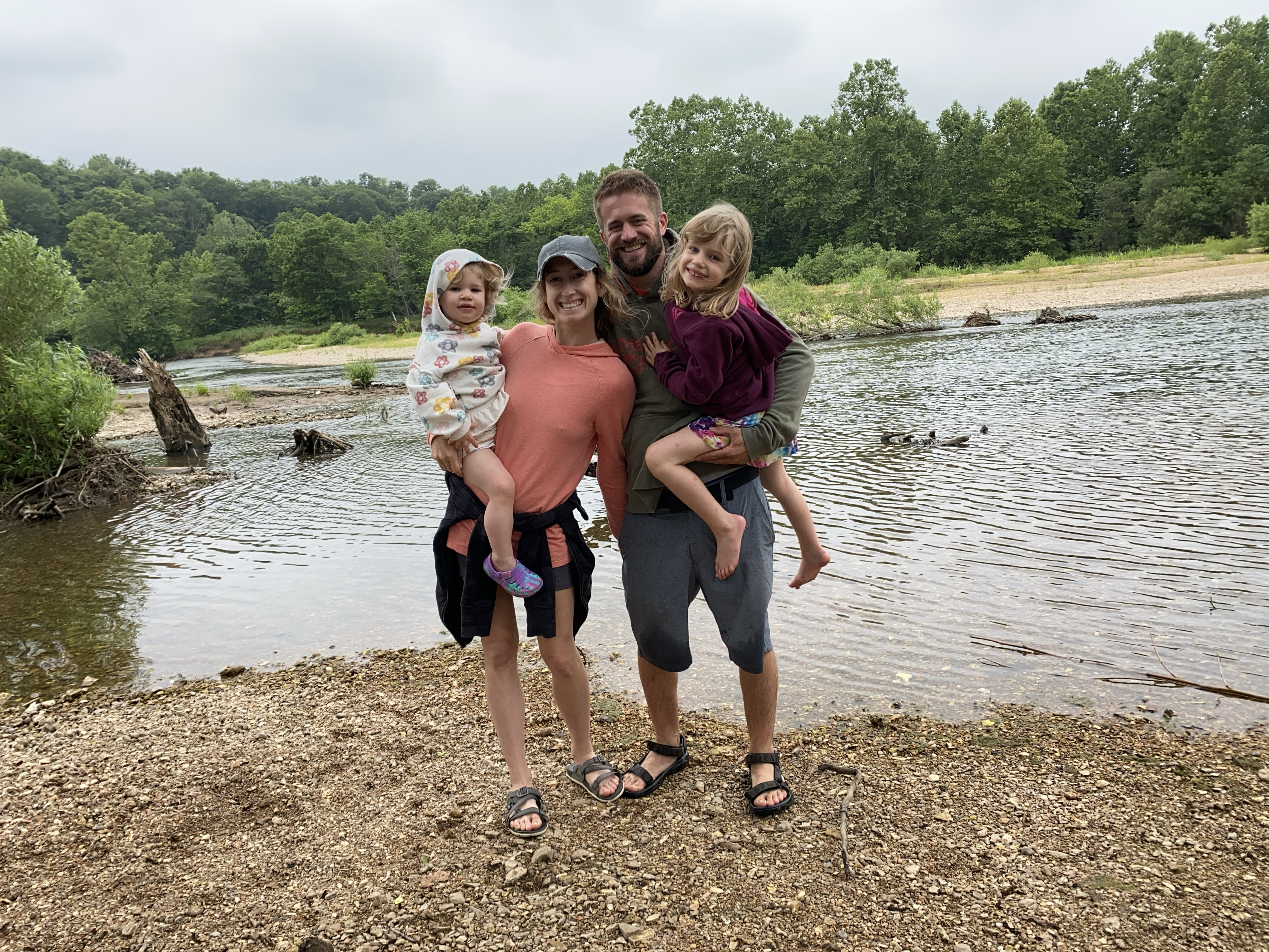 A picture of a family at a lake.