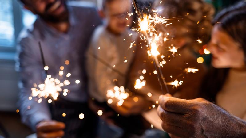 A photo of people playing with sprinkler fireworks.
