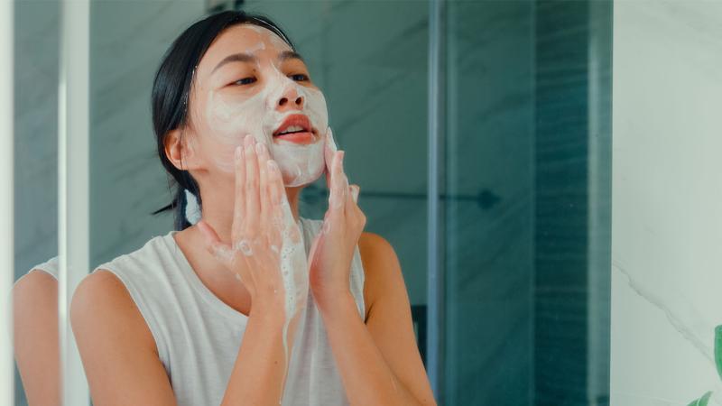 woman washing her face