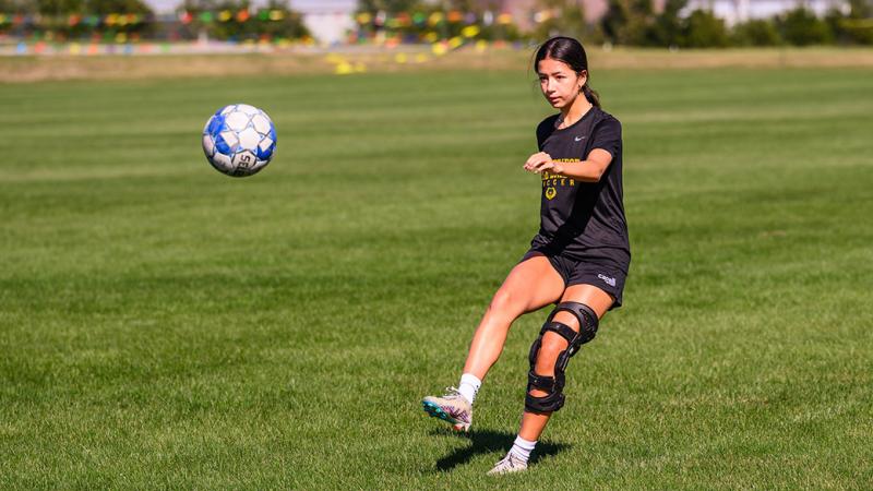 A photo of a girl playing soccer.