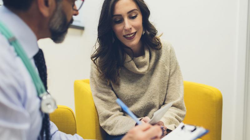 A woman speaking with a physician.