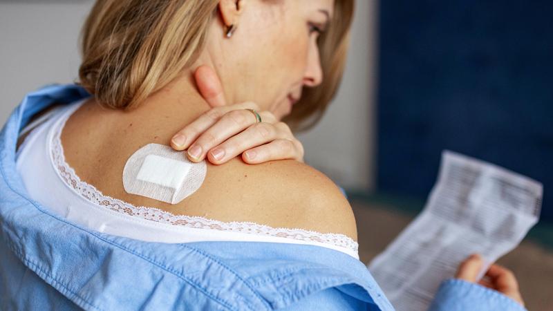 A photo of a woman reading over a prescription.