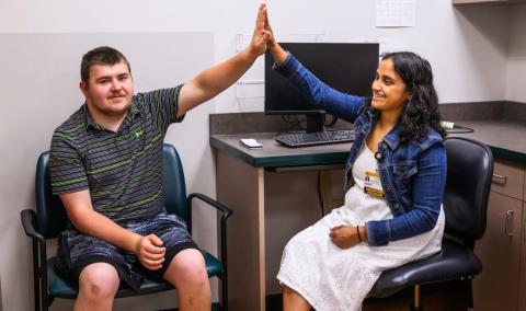 A man and a woman giving a high five.