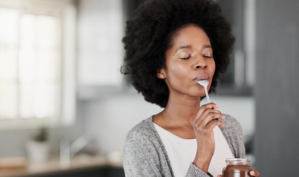 A photo of a woman eating some food.